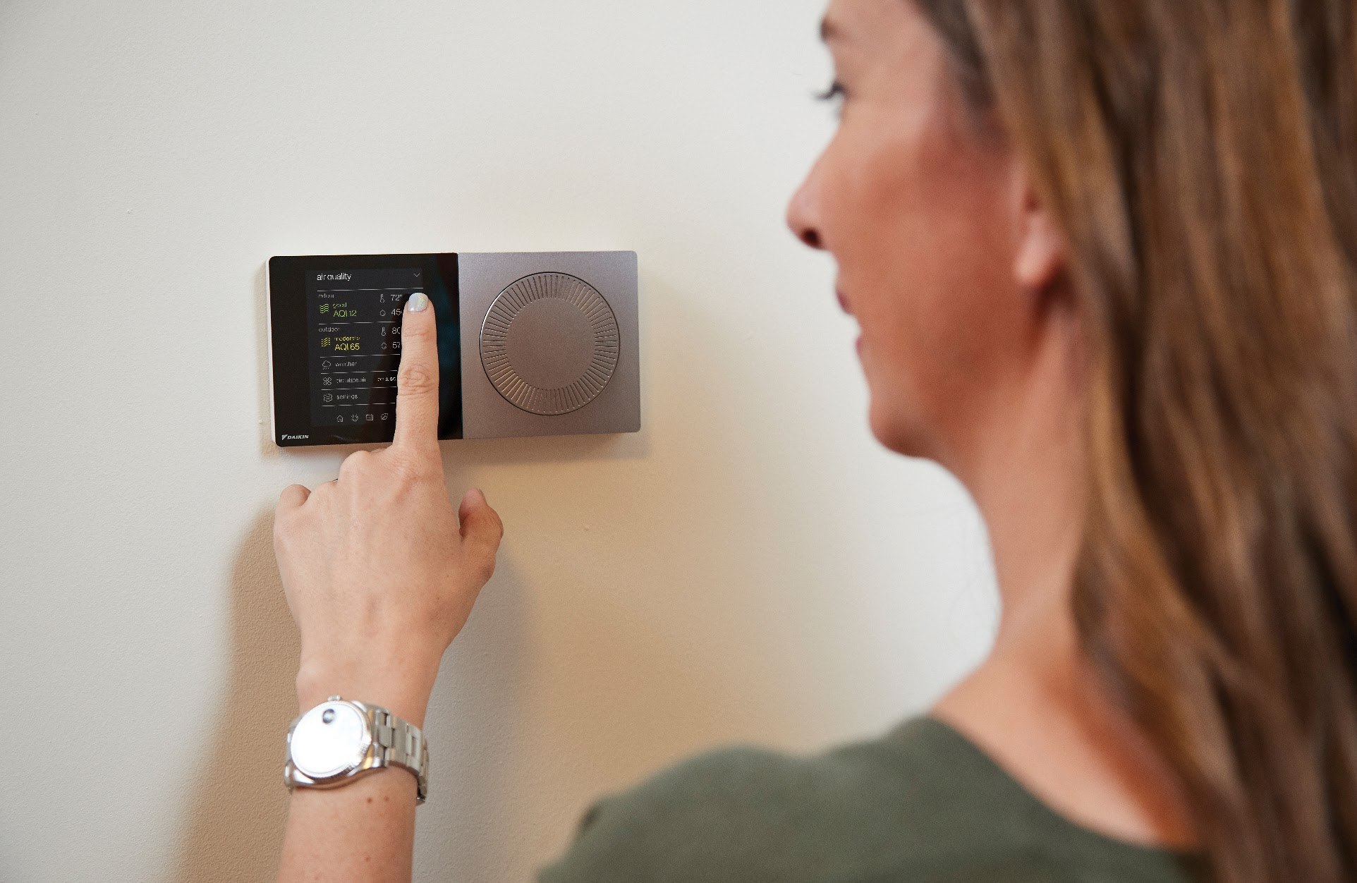 Woman Using Daikin Thermostat